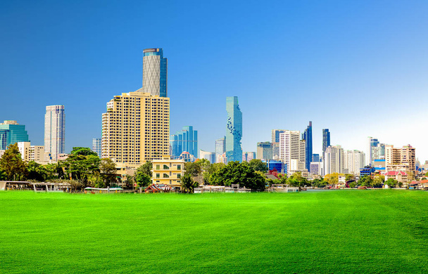 Cityscape office building with modern corporate architecture - business ideas and success. Panoramic skyline and modern business office buildings. green lawn with modern building - Photo, Image