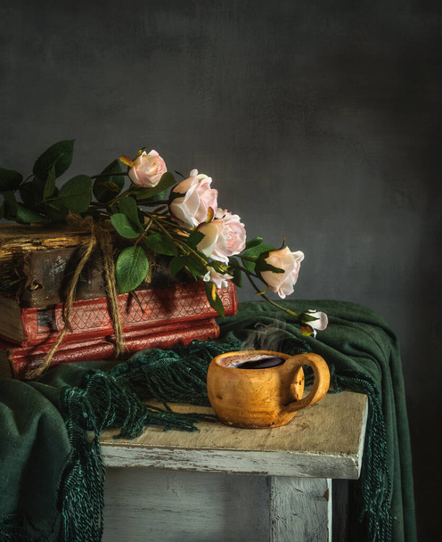 Still life with a bouquet of roses, a cup of coffee and books. Vintage. - Fotografie, Obrázek