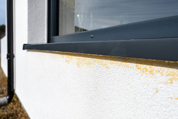 Yellow mounting foam filled under the window sill, white plaster is stained by sloppy work. - Photo, Image