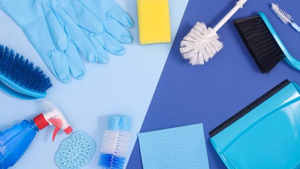 Creative copy space frame background with cleaning tools on pastel and deep blue theme. Flat lay - Foto, immagini