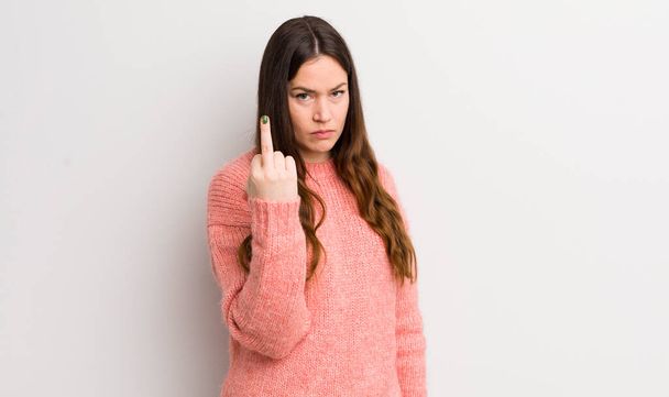 pretty caucasian woman feeling angry, annoyed, rebellious and aggressive, flipping the middle finger, fighting back - Foto, Imagen