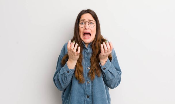 pretty caucasian woman looking desperate and frustrated, stressed, unhappy and annoyed, shouting and screaming - Photo, Image