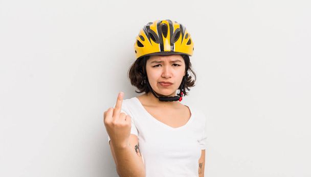 pretty hispanic girl feeling angry, annoyed, rebellious and aggressive. bike concept - Fotó, kép