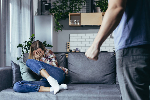 Family quarrel, couple man and woman, domestic violence, family crisis woman sitting on sofa and crying - Fotoğraf, Görsel