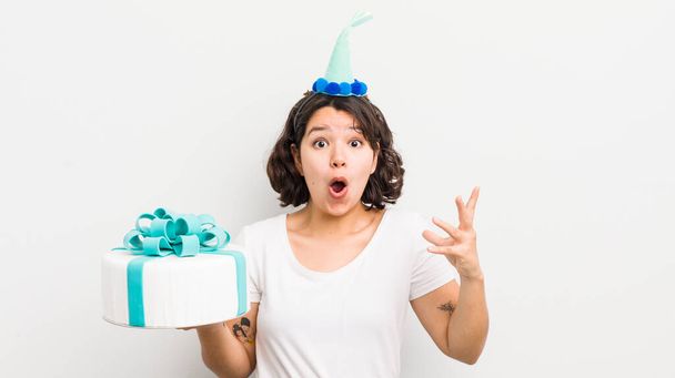 pretty hispanic girl feeling extremely shocked and surprised. birthday concept - Photo, Image