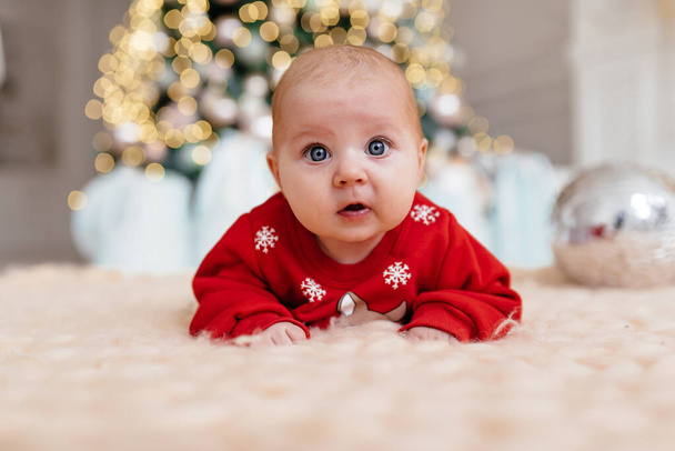 A small child in a beautiful Christmas costume - Φωτογραφία, εικόνα