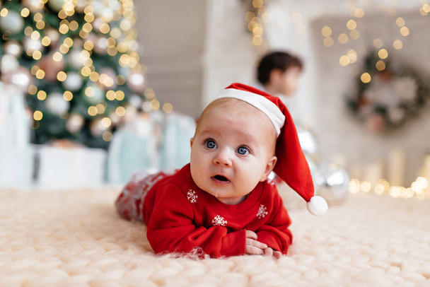 A small child in a beautiful Christmas costume - Φωτογραφία, εικόνα