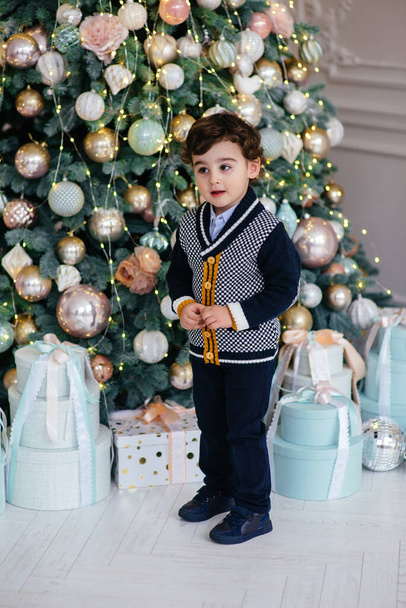 Little happy boy near the Christmas tree - Φωτογραφία, εικόνα