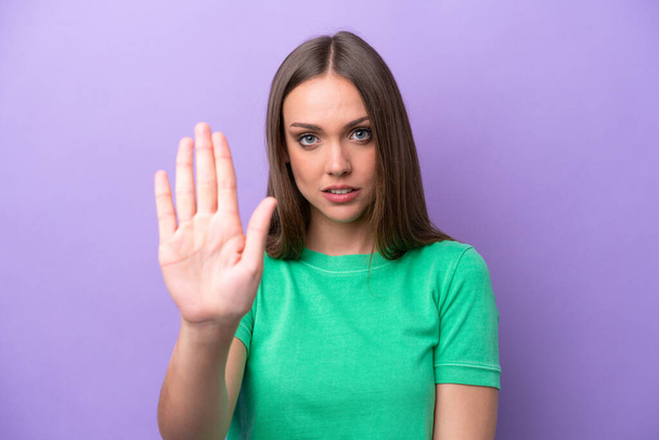 Young caucasian woman isolated on purple background making stop gesture - Φωτογραφία, εικόνα