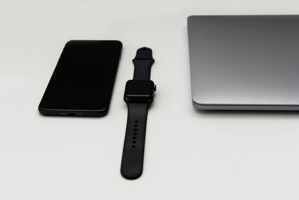 Ноутбук з годинником і мобільний телефон на білому тлі
 - Фото, зображення