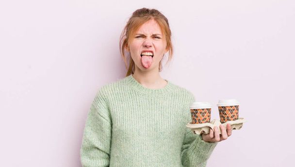 redhead pretty girl feeling disgusted and irritated and tongue out. take away coffee concept - Φωτογραφία, εικόνα