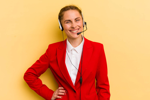 young pretty woman smiling happily with a hand on hip and confident. telemarketer concept - Φωτογραφία, εικόνα