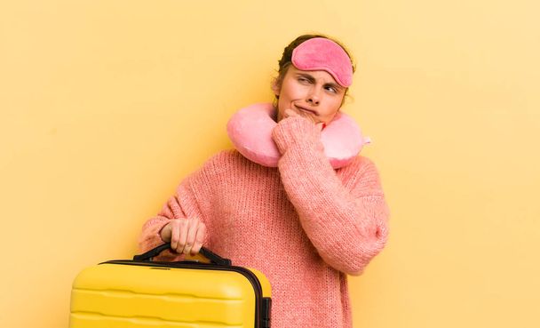 young pretty woman thinking, feeling doubtful and confused. flight passenger concept - 写真・画像