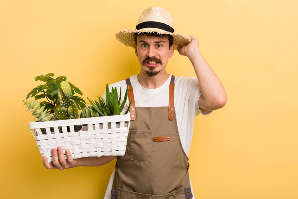 man feeling stressed, anxious or scared, with hands on head. gardener concept - Photo, image