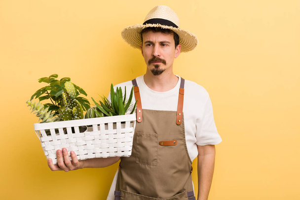 man feeling sad, upset or angry and looking to the side. gardener concept - Photo, image