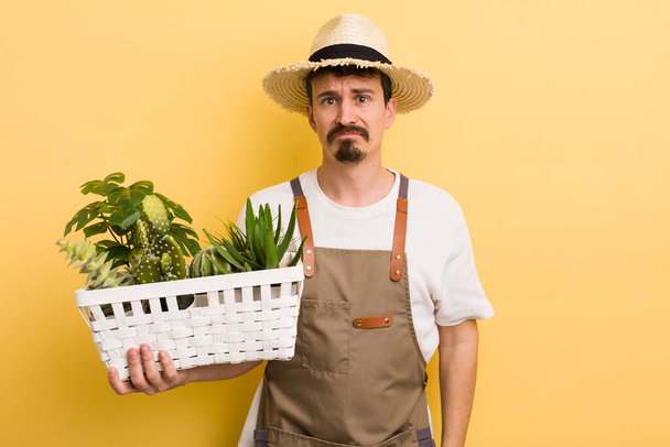 man feeling sad and whiney with an unhappy look and crying. gardener concept - Photo, image
