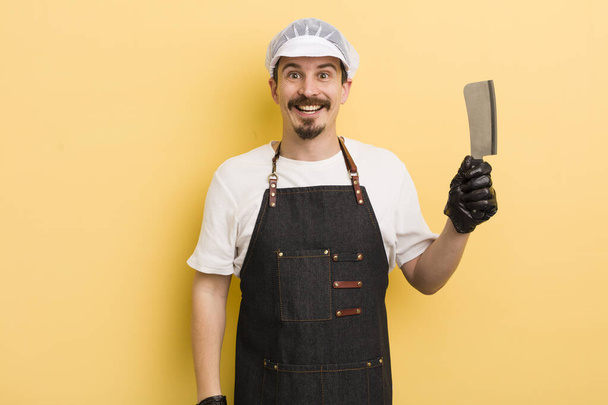 man looking happy and pleasantly surprised. butcher concept - Photo, Image