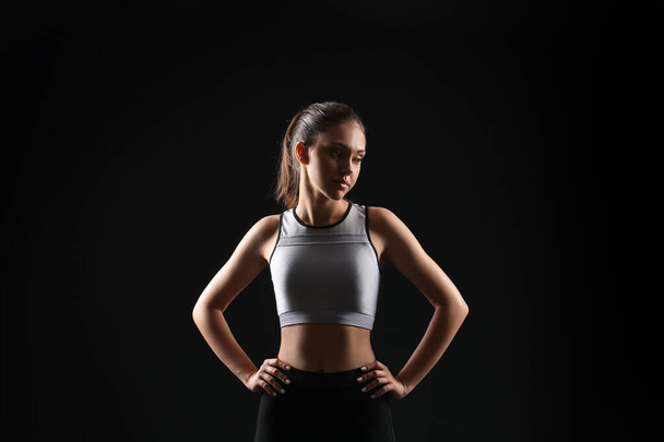 Sporty teenage girl on black background - Фото, зображення