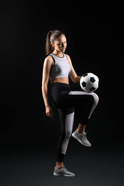 Sporty teenage girl with ball on black background - Photo, Image