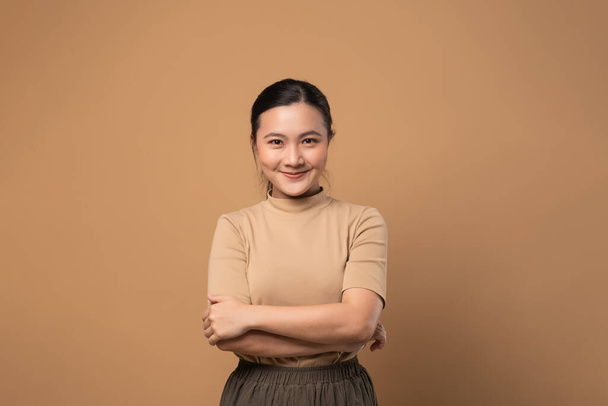 Asian woman happy confident ,looking at camera, isolated on beige background. - Фото, зображення