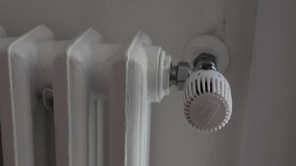Male turning down the heating adjusting radiator valve. Energy saving concept - Footage, Video
