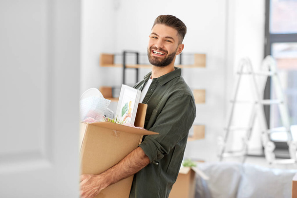 happy man with box moving to new home - Φωτογραφία, εικόνα