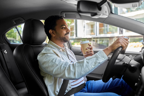 happy indian man or driver with coffee driving car - Fotografie, Obrázek