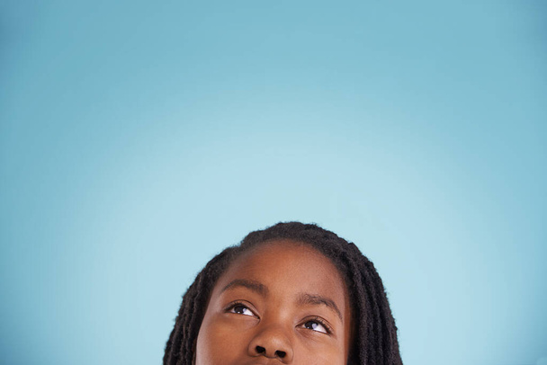 Getting creative. Cropped studio shot of a thoughtful young boy against a blue background. - Photo, Image