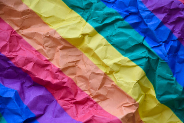 Pattern of a wrinkled sheet of rainbow paper which was left by the side of the road. concept for lgbt celebrations in pride month, soft and selective focus. - Photo, Image