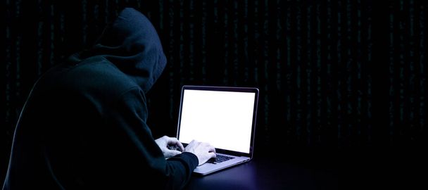 Cyber security hacker concept. Internet web hack technology. Digital laptop in hacker man hand isolated on black banner. Data protection, secured internet access, cybersecurity - Фото, зображення