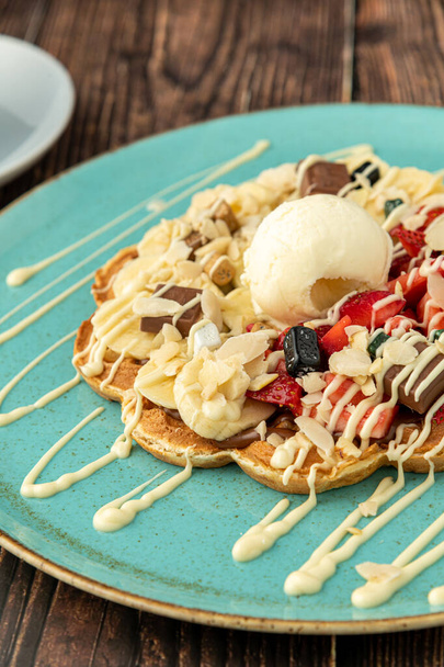 Heart waffle with banana and strawberry with gummy candy and ice cream on it - Φωτογραφία, εικόνα