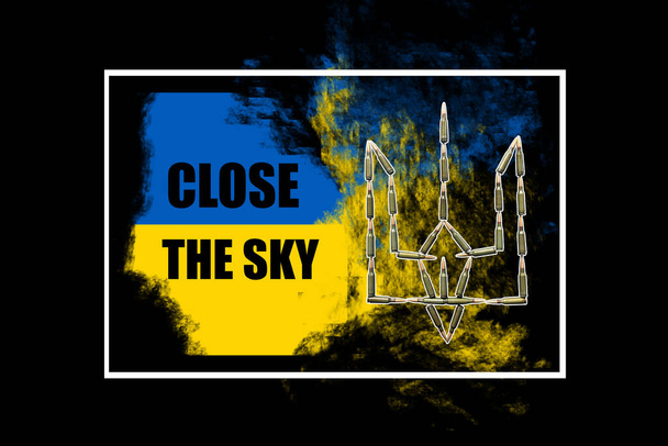 Protest and protection of the civilian population of Ukraine from military aggression and bombing of cities. Close The Sky slogan in the flag of Ukraine. - Photo, Image