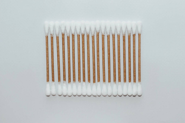 Eco-friendly bamboo cosmetic cotton buds on a light background. - Foto, Imagen