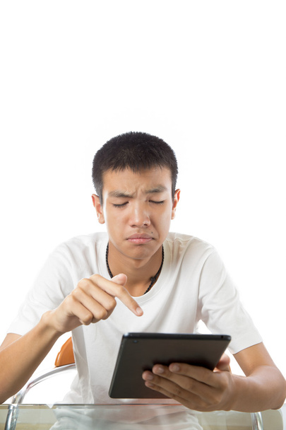 Asian teenager using his tablet or ipad with funny face - Foto, immagini