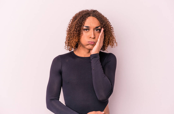 Young latin transsexual woman isolated on pink background blows cheeks, has tired expression. Facial expression concept. - Φωτογραφία, εικόνα