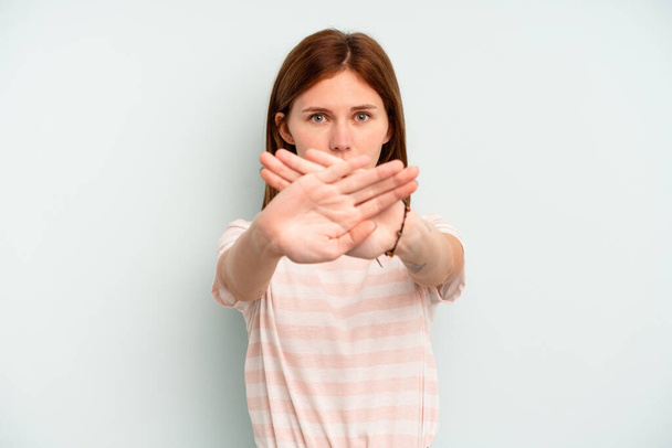 Young English woman isolated on blue background doing a denial gesture - Photo, Image