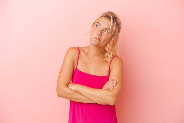 Young Russian woman isolated on pink background dreaming of achieving goals and purposes - Valokuva, kuva