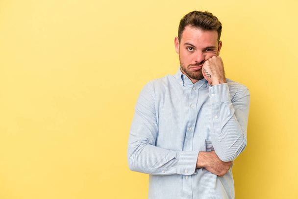 Young caucasian man isolated on yellow background who feels sad and pensive, looking at copy space. - Fotoğraf, Görsel