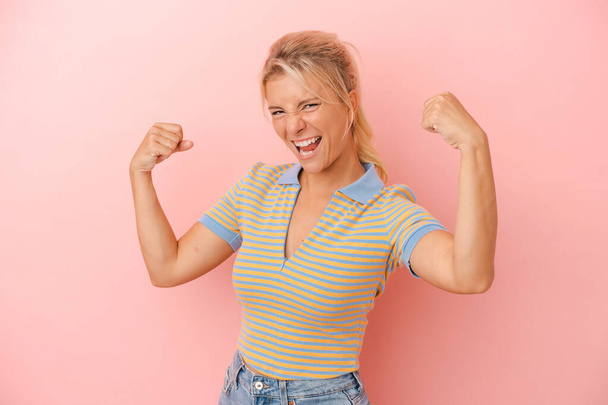 Young Russian woman isolated on pink background cheering carefree and excited. Victory concept. - Fotografie, Obrázek