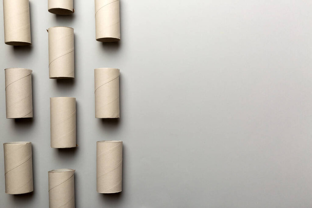 Flat lay composition with empty toilet paper rolls and space for text on color background. Recyclable paper tube with metal plug end made of kraft paper or cardboard. - Photo, Image
