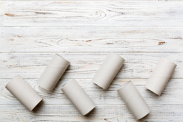 Flat lay composition with empty toilet paper rolls and space for text on color background. Recyclable paper tube with metal plug end made of kraft paper or cardboard. - Photo, Image