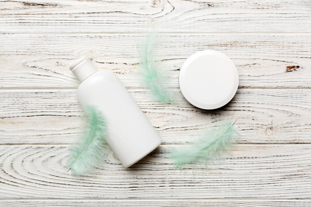 Spa cosmetic product, cream jar, branding mock up, top view with feathers background. Flat lay. - Фото, зображення