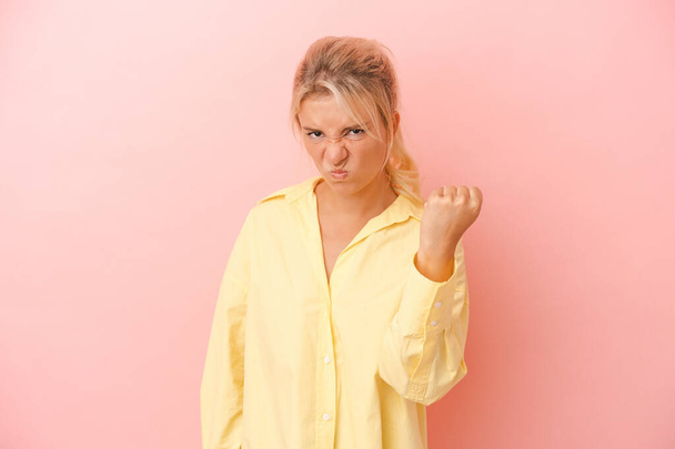 Young Russian woman isolated on pink background showing fist to camera, aggressive facial expression. - Photo, Image