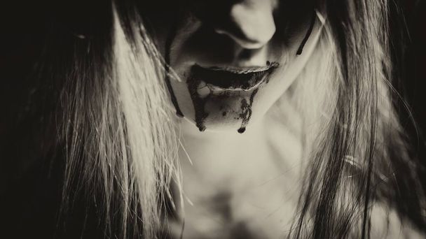 Woman with bloody mouth closeup photo - Foto, Bild