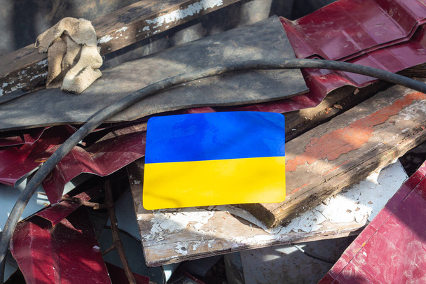 Symbolic Ukrainian flag on a ruins of a house in Ukraine - Photo, Image