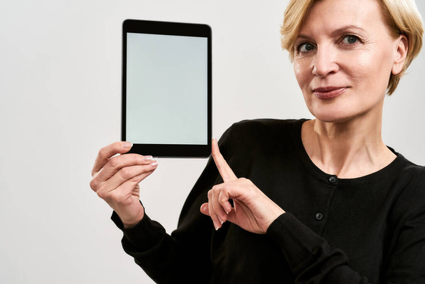 Partial image of serious woman show digital tablet - Foto, Imagem