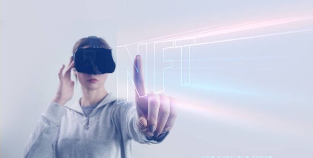  Portrait of woman with VR glasses creating and trading with non-fungible token. Virtual reality experience and future technology concept. - Foto, Imagen
