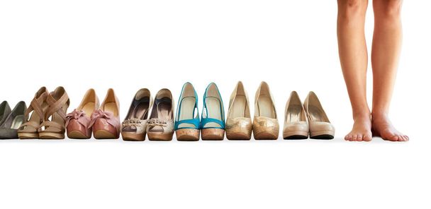 Footwear for every outfit. Cropped image of a woman standing next to a row of shoes isolated on white. - Foto, immagini