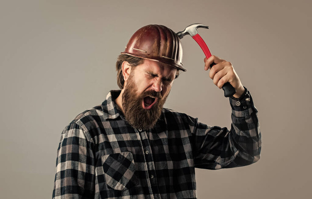 male worker in uniform with hammer. builder guy with working tool. brutal mature hipster - Photo, image
