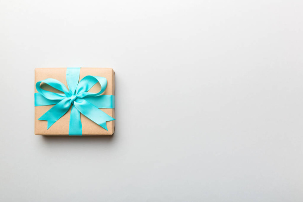 Holiday present box over colored background, top view. Copy space for design. - Φωτογραφία, εικόνα